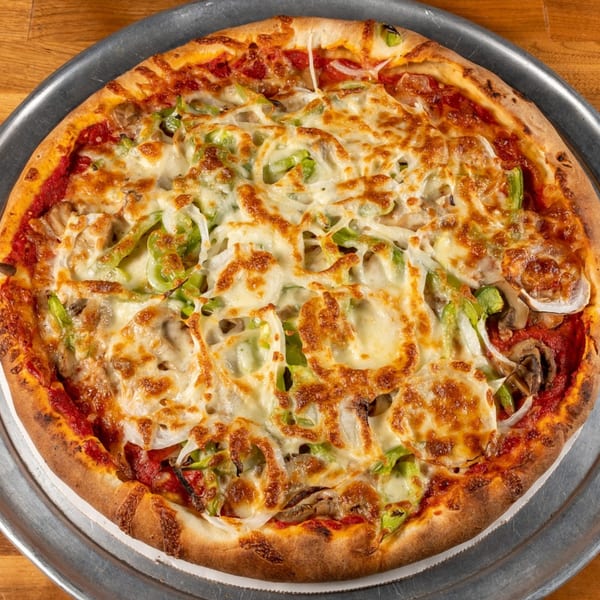 Angie's Restaurant & Pizzeria's whole pizza with melted cheese, green peppers, onions, and mushrooms.